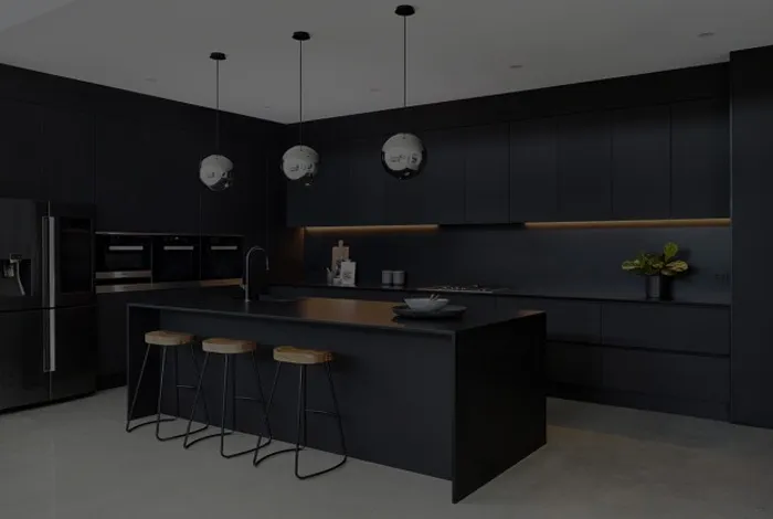 A sleek dark fitted kitchen with an island counter, showcasing KCT Kitchens' craftsmanship